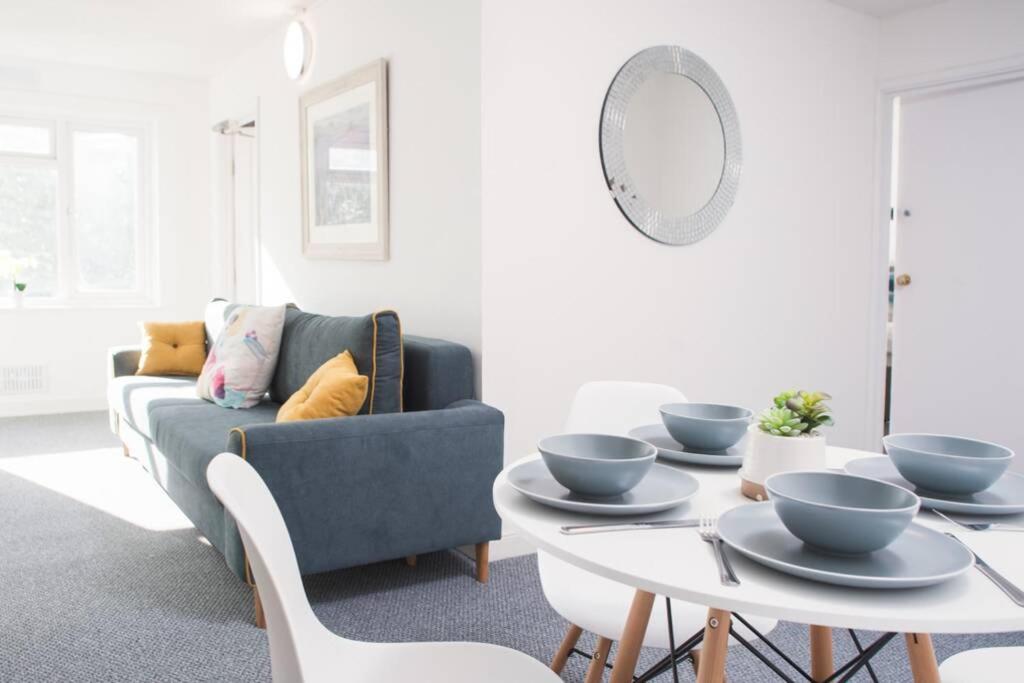 a living room with a couch and a table with bowls on it at Brynglas Newport flat sleeps 8 - Mycityhaven in Newport
