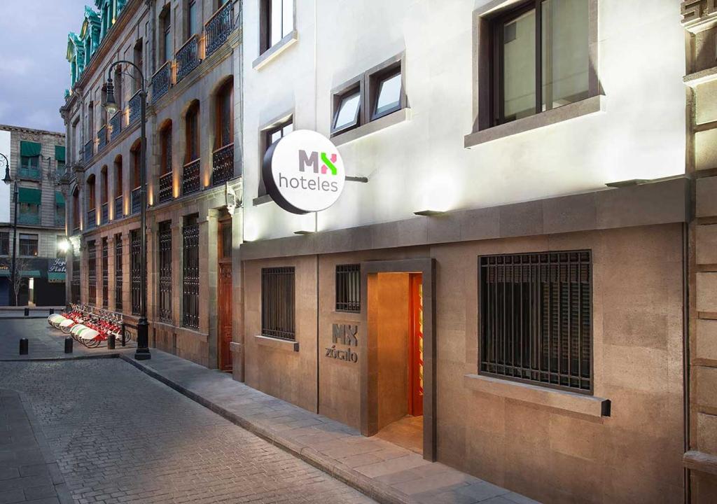 a building with a sign on the side of a street at Hotel MX zócalo in Mexico City