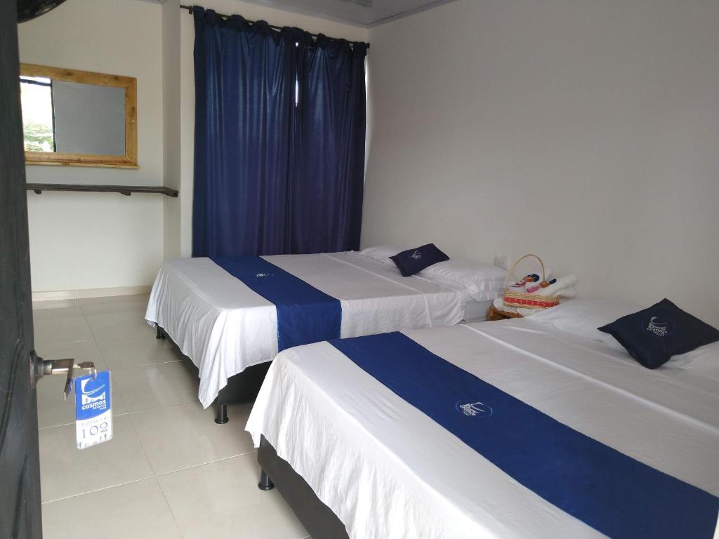 Postel nebo postele na pokoji v ubytování Cosmos Tatacoa Hotel