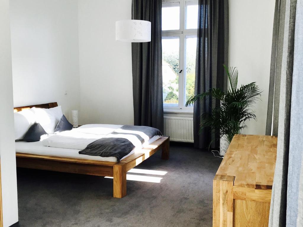 Postel nebo postele na pokoji v ubytování Dein Gutshof Hotel & Ferienwohnungen
