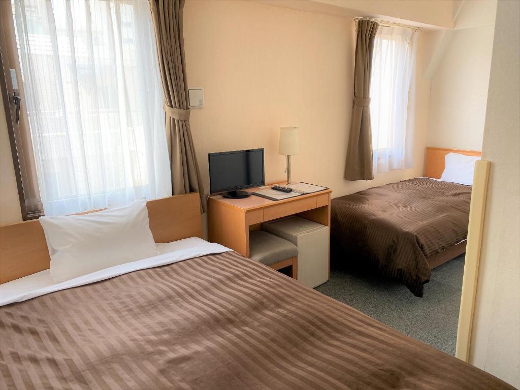 Postel nebo postele na pokoji v ubytování Sakura Hotel Hatagaya