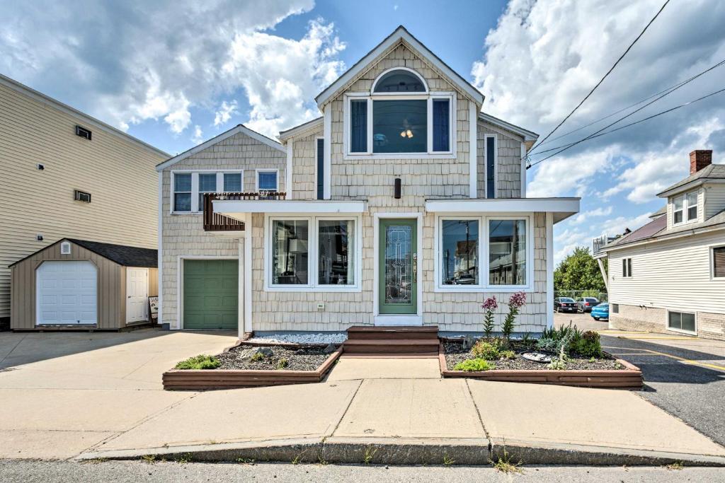 a large white house with a garage at Sun-Soaked Coastal Cottage with Deck and Walk to Beach in Old Orchard Beach