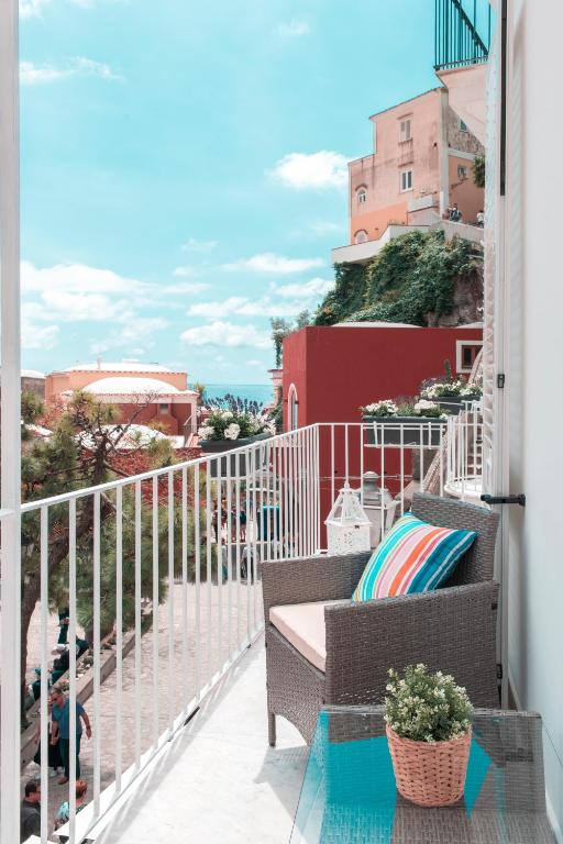 a balcony with a bench and a view of the ocean at Casa Lucienne in Positano