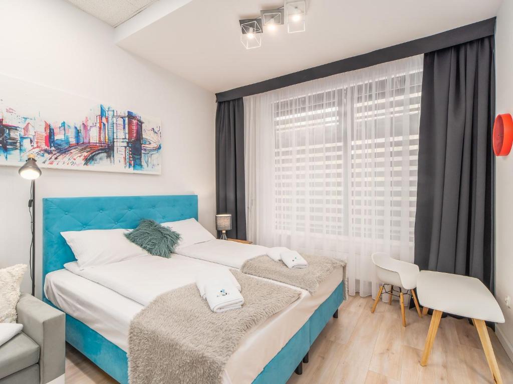 Posteľ alebo postele v izbe v ubytovaní ApartmentyPrzyMorzu Ogrody