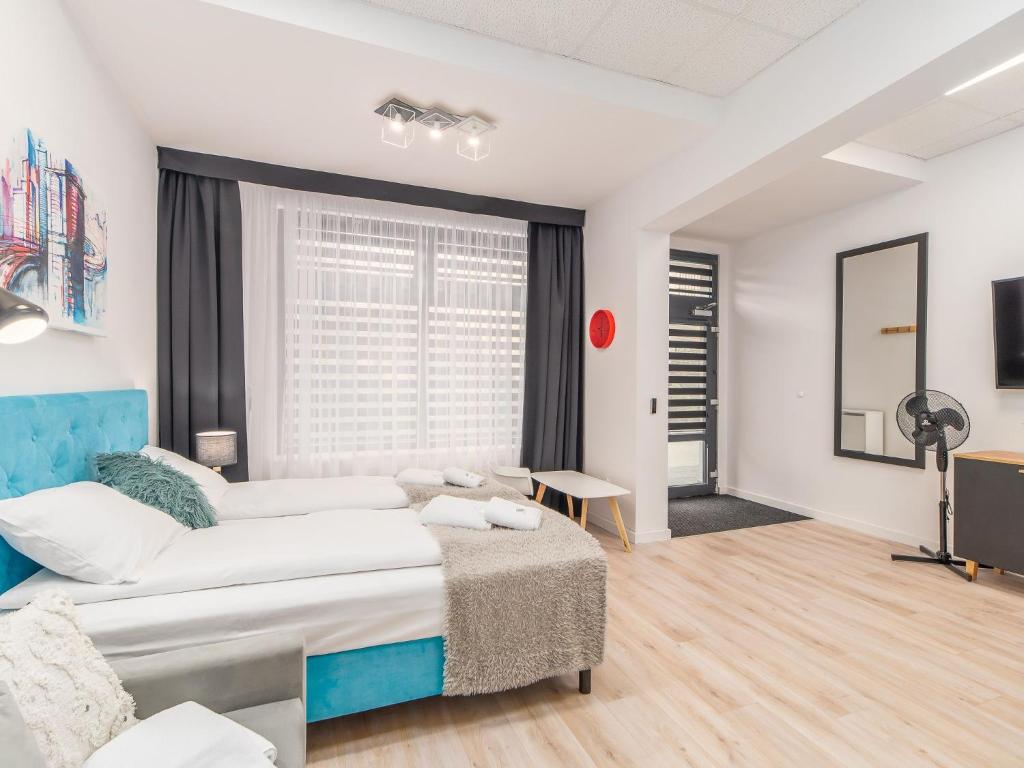 Posteľ alebo postele v izbe v ubytovaní ApartmentyPrzyMorzu Ogrody