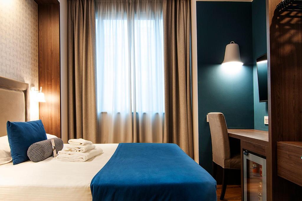 Postel nebo postele na pokoji v ubytování Fly Decó Hotel