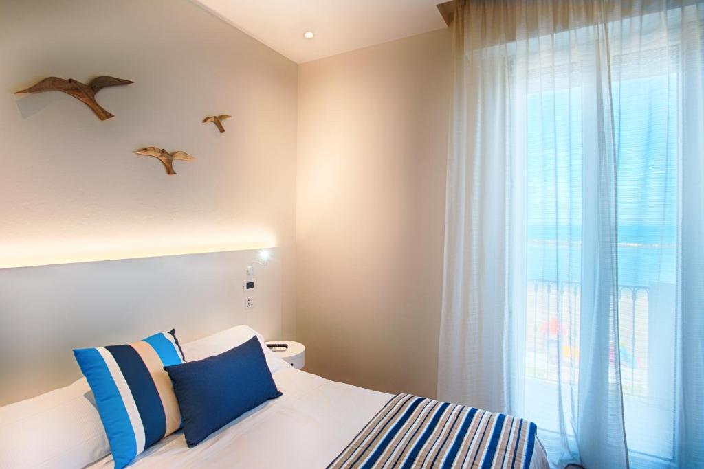 Postel nebo postele na pokoji v ubytování Hotel Agostini