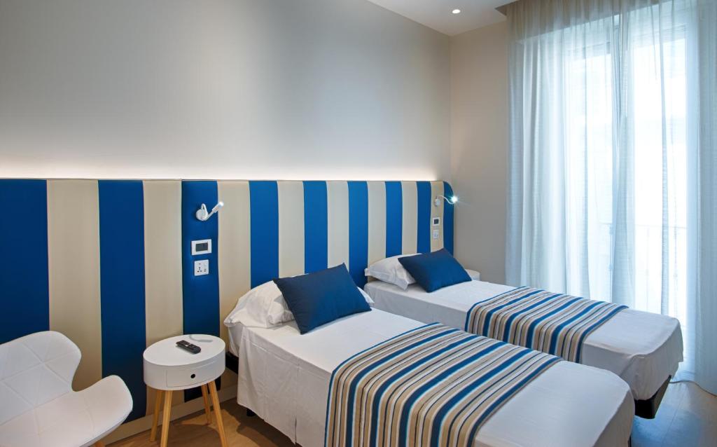 Postel nebo postele na pokoji v ubytování Hotel Agostini