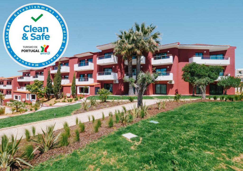 a building with a sign that reads clean and safe at Topazio Vibe Beach Hotel & Apartments - Adults Friendly in Albufeira