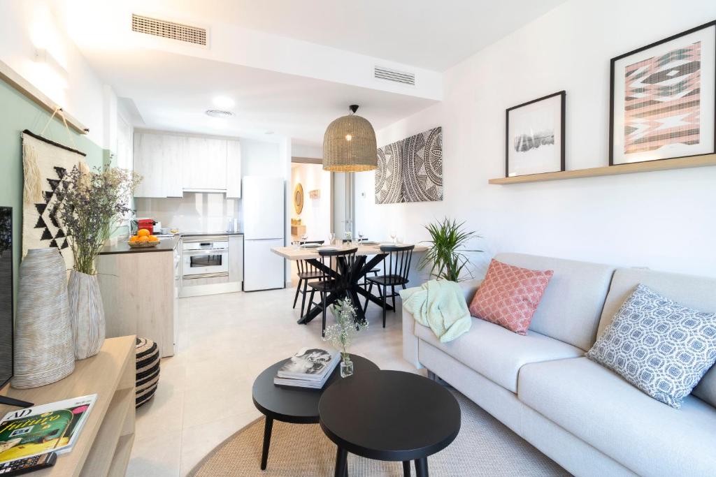 - un salon avec un canapé et une table dans l'établissement Calafell Home Apartments, à Calafell