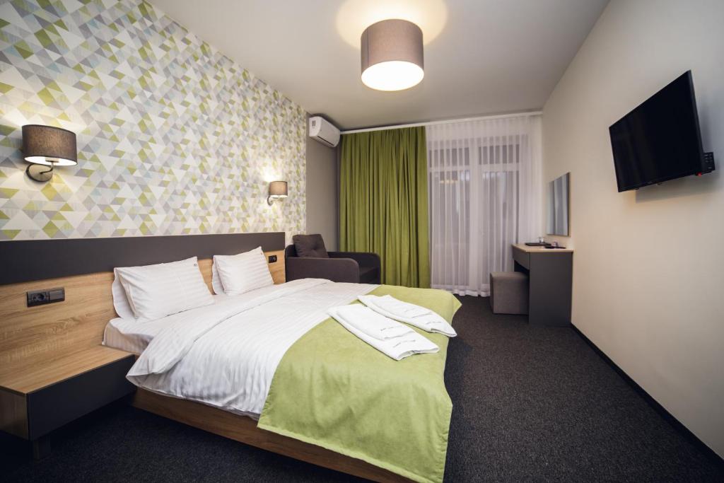 Postel nebo postele na pokoji v ubytování Arena Apart - Hotel