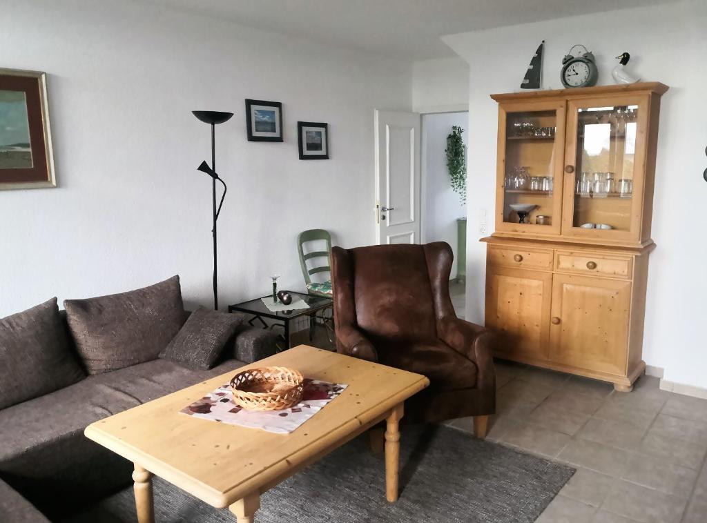 a living room with a couch and a table at Das Landhaus am Haff LHH B06 in Stolpe