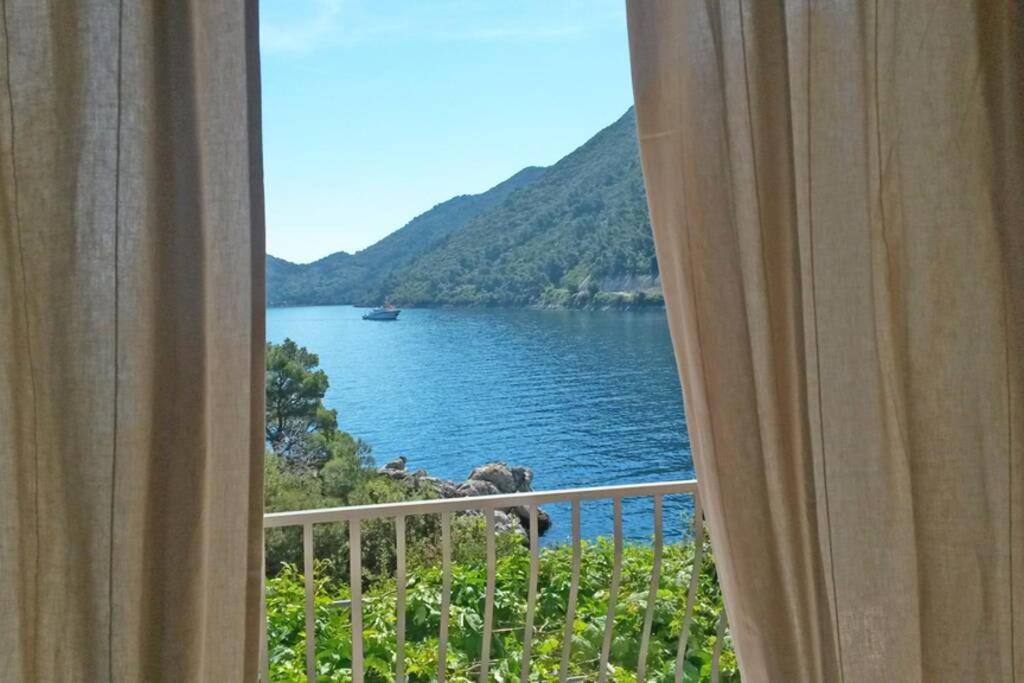 a view of a lake from a window at Mljet 2 You - seafront apartment 2+2 in Sobra