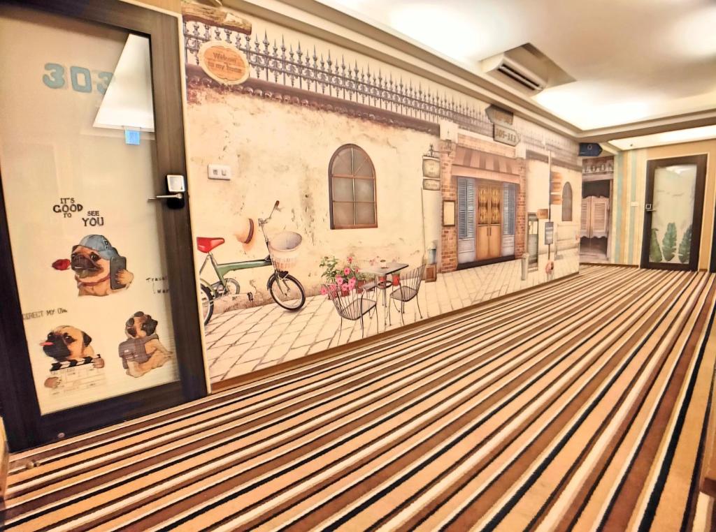 a hallway with a dog mural on the wall at Sanduo Hotel in Kaohsiung