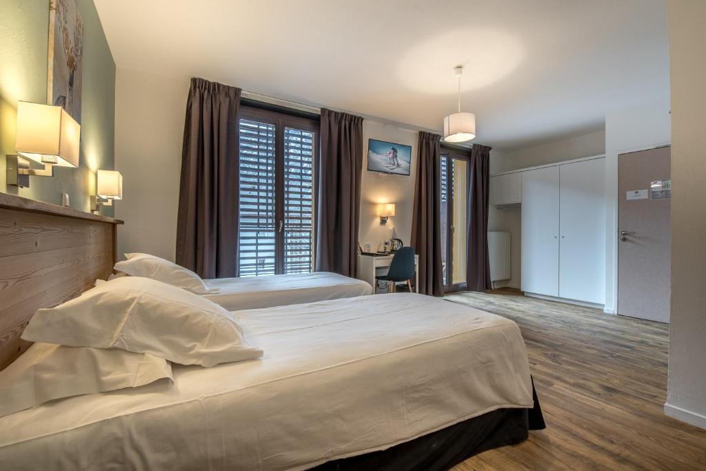 Postel nebo postele na pokoji v ubytování Hôtel Le Marintan