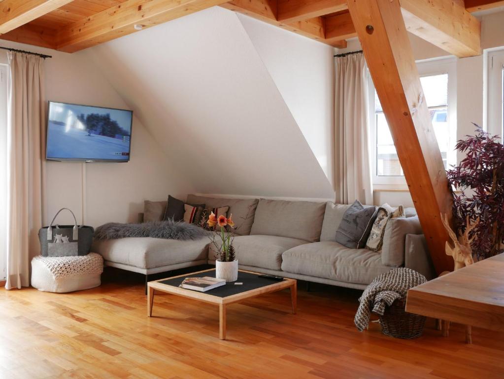 a living room with a couch and a table at Oskar's Chalets in Hinterzarten