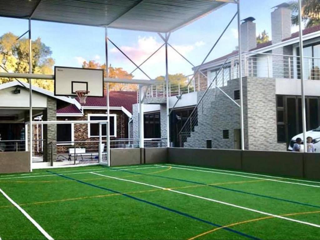 a tennis court with a basketball hoop on a house at C&C HOTEL VIBES Randpark Ridge JHB 14 Units Available in Boskruin