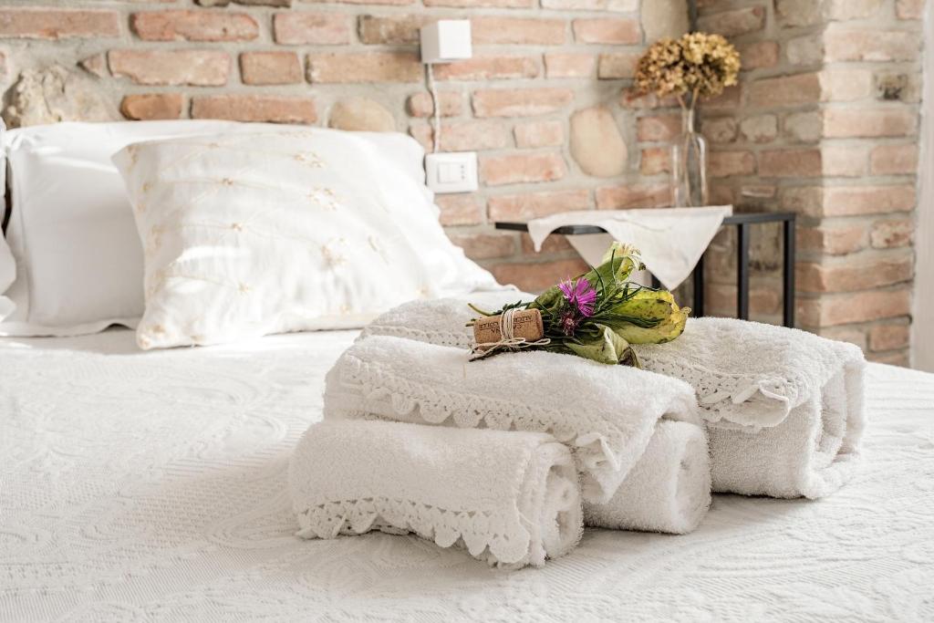 a white bed with towels on top of it at Villa Curte Nicia in Nizza Monferrato