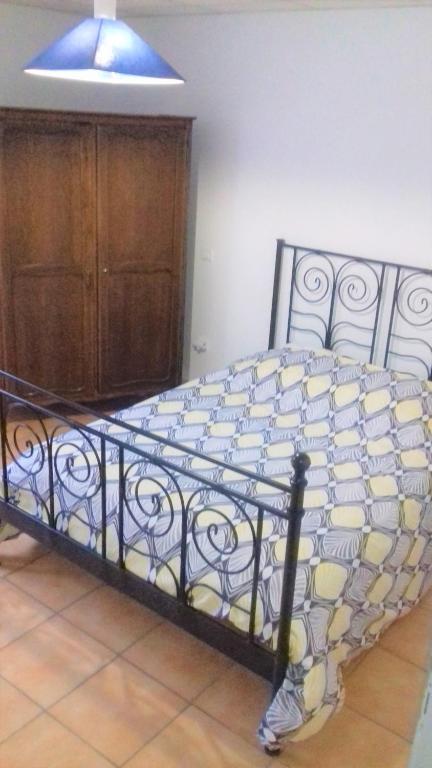 a bed in a bedroom with a blue light at Appartement &quot;Jardins&quot; in Pesmes