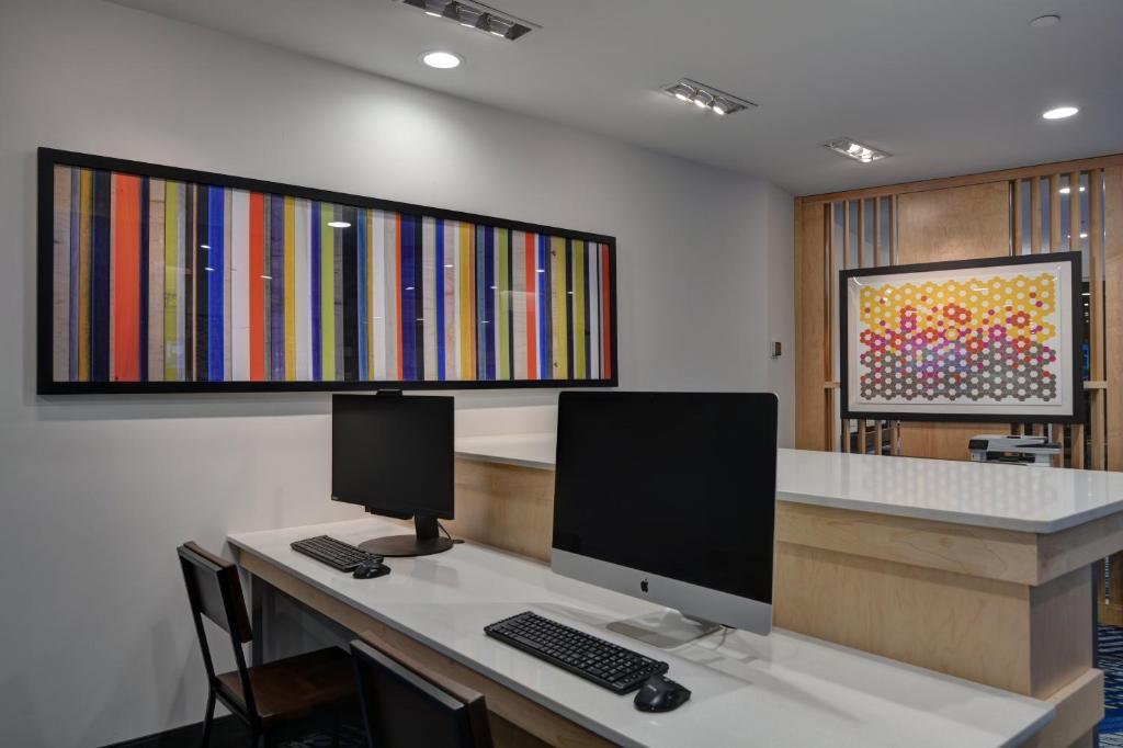 an office with a desk with a computer on it at Holiday Inn Express & Suites - Greenville - Taylors by IHG in Greenville