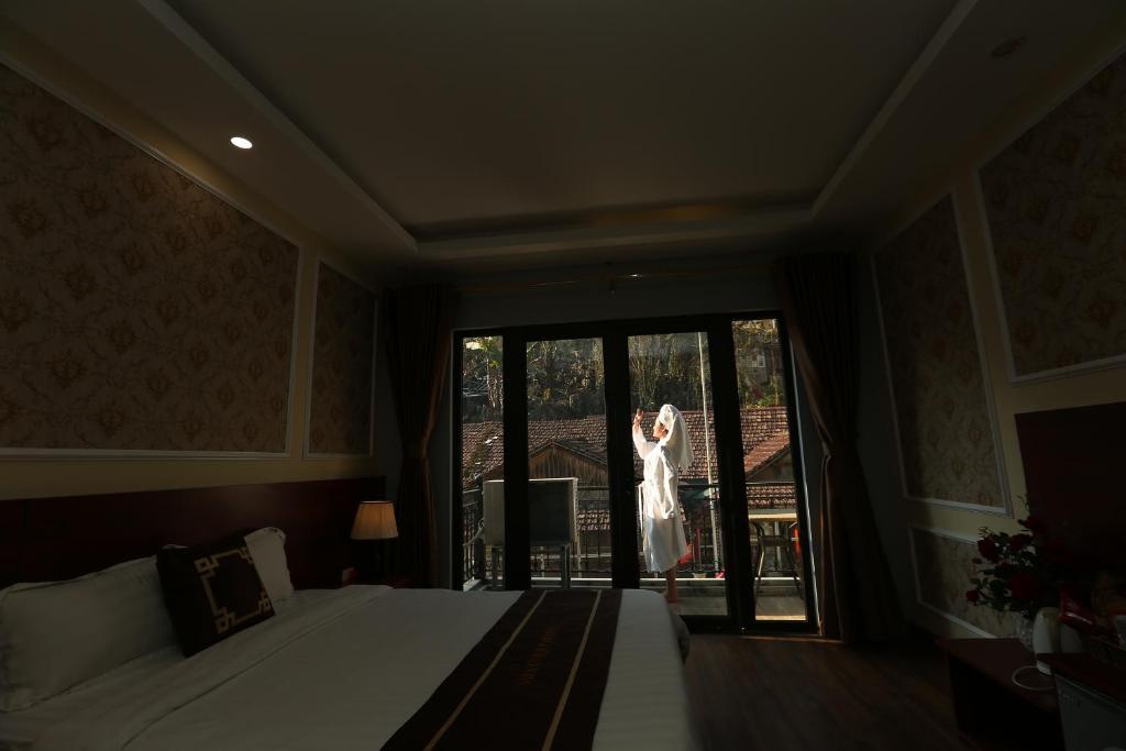 Postel nebo postele na pokoji v ubytování Sapa Unique Hotel