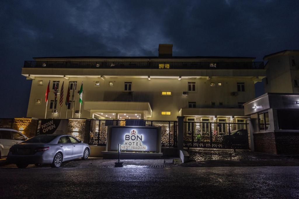 a car parked in front of a building at night at BON Hotel Nest Ibadan in Ibadan