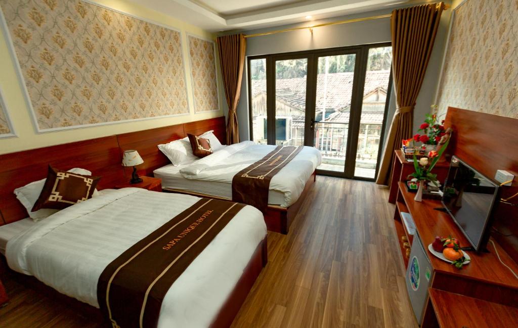 Postel nebo postele na pokoji v ubytování Sapa Unique Hotel