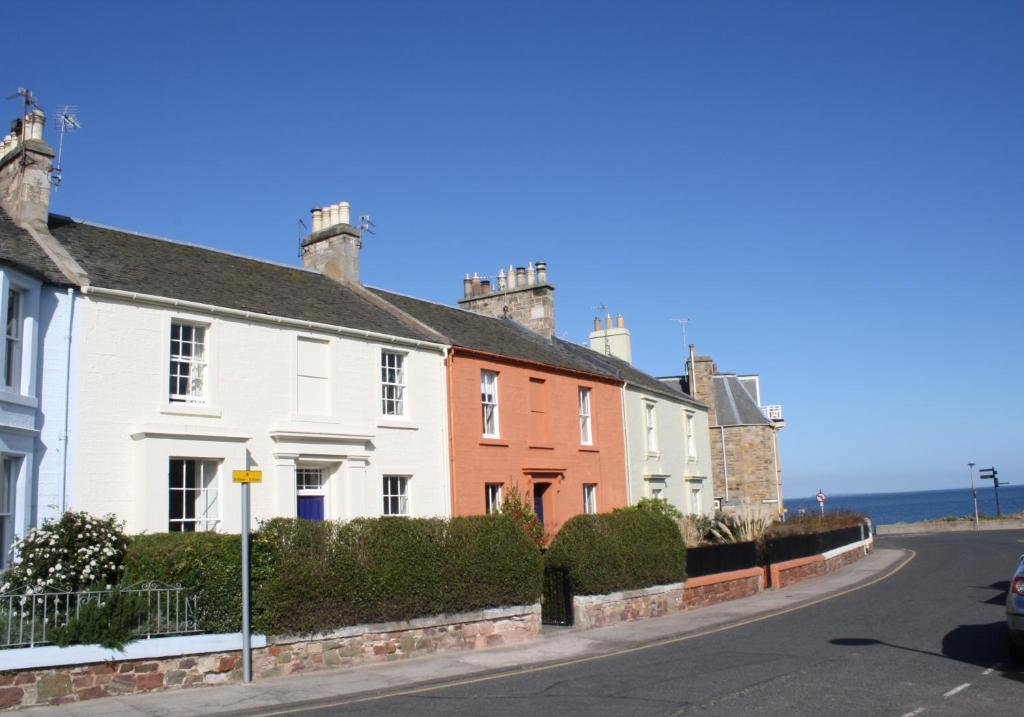 a row of houses on the side of a street at Guillemots in North Berwick