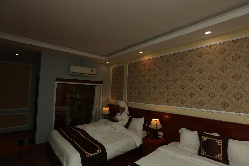 Postel nebo postele na pokoji v ubytování Sapa Unique Hotel