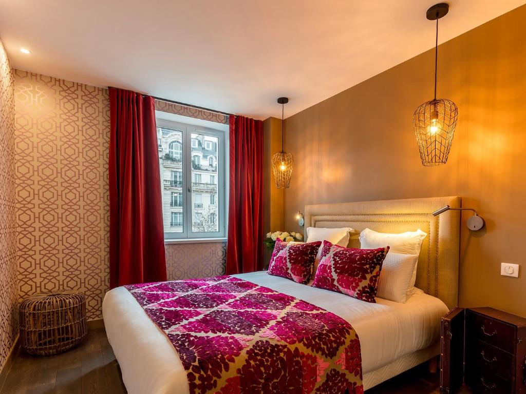 a bedroom with a large bed with red curtains at BE YOU LUXURY APART'HÔTEL - LA POUDRÉE in Paris