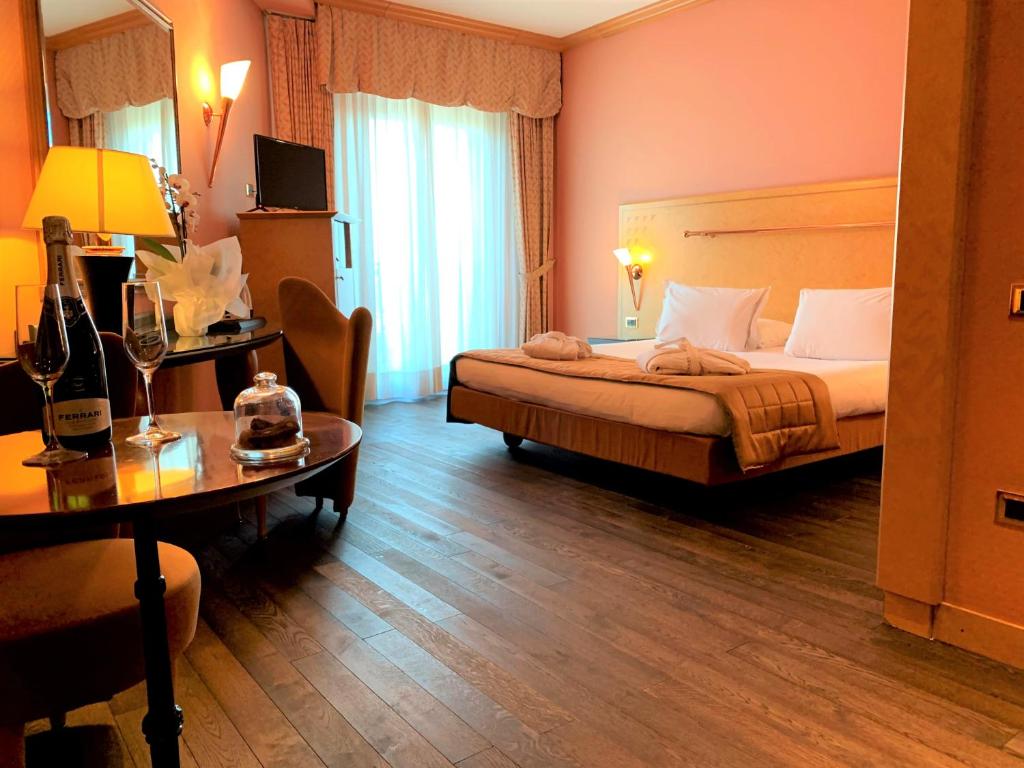 a hotel room with a bed and a table at SHG Hotel Antonella in Pomezia