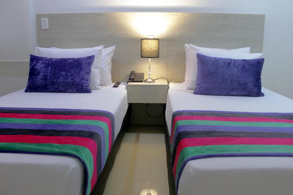 Postel nebo postele na pokoji v ubytování Hotel Suite Comfort