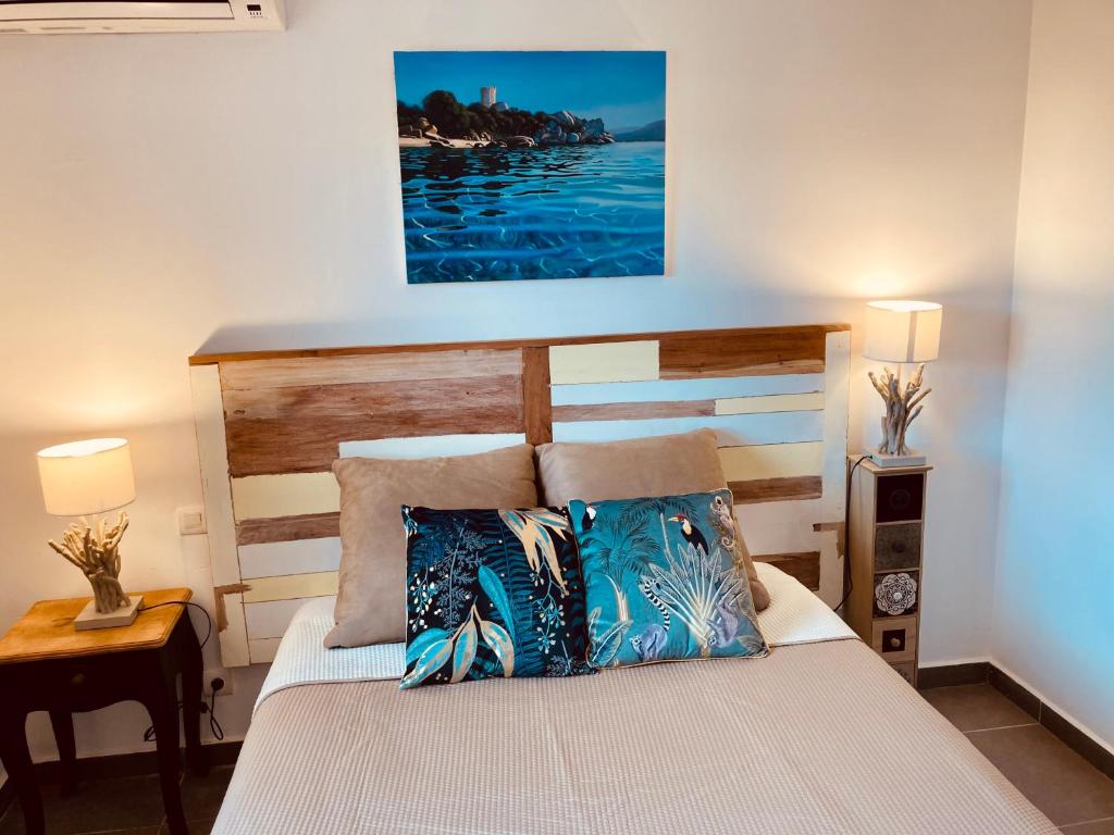a bed with two pillows on it in a bedroom at Appartement Cemiliana in Bonifacio