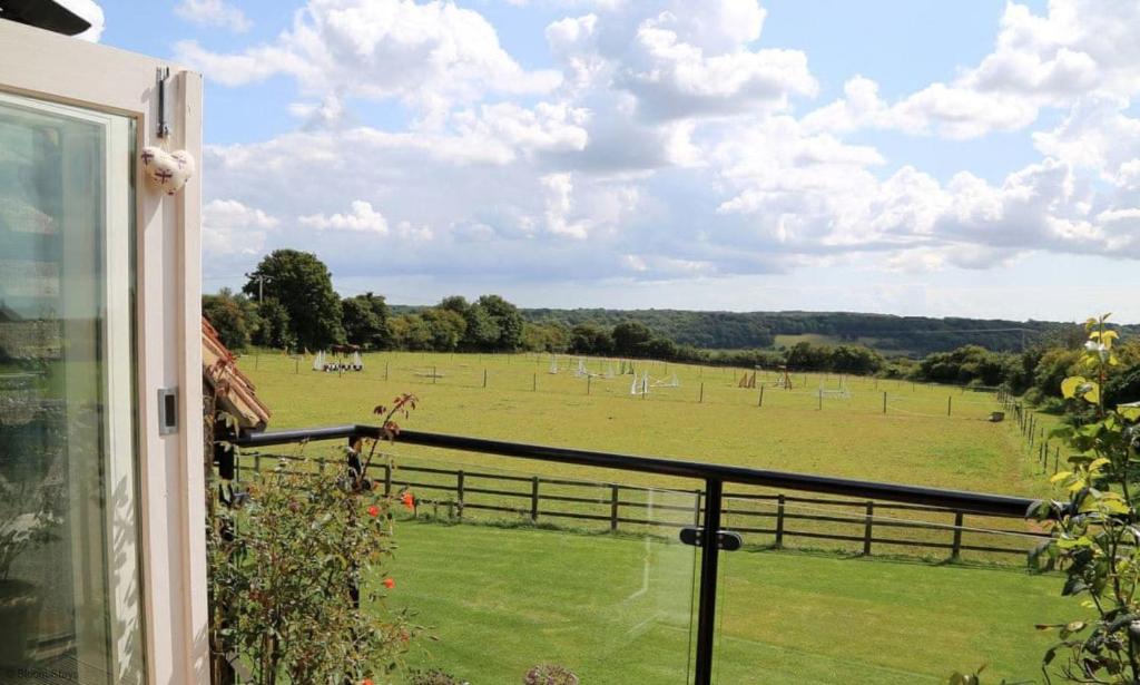 a view of a field from a window at The Chestnuts by Bloom Stays in Canterbury