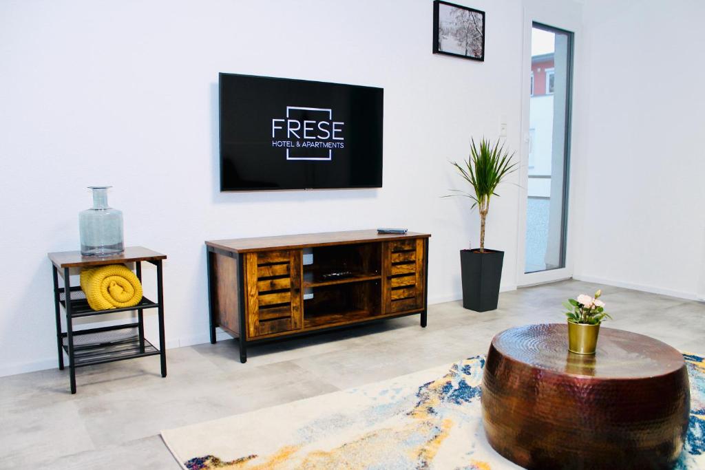 a living room with a coffee table and a tv at Frevor - DESIGN L - I in Ulm