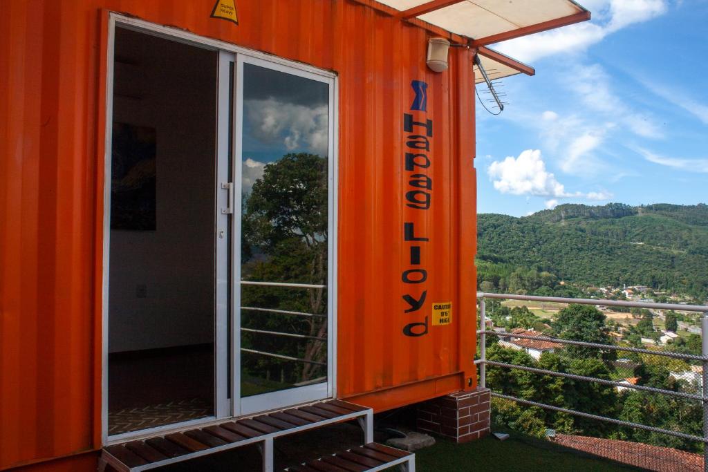 an orange house with a view of the mountains at Amsterdam lofts 3 in Poços de Caldas