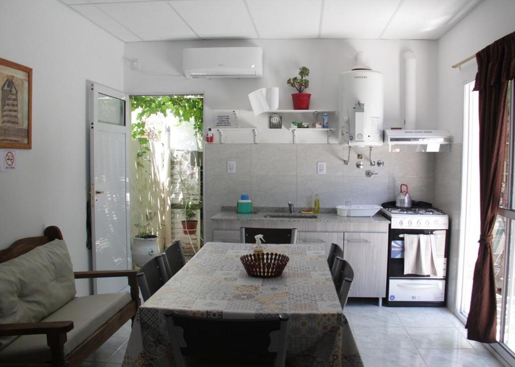 a kitchen with a table and a kitchen with a stove at ALOJAMIENTO SARMIENTO in General Alvear