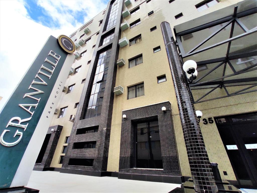 a large building with a clock on the side of it at Granville Hotel in Curitiba