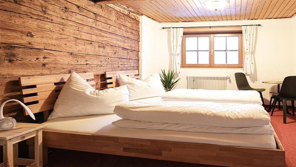 A bed or beds in a room at Landhaus Sommerbichl