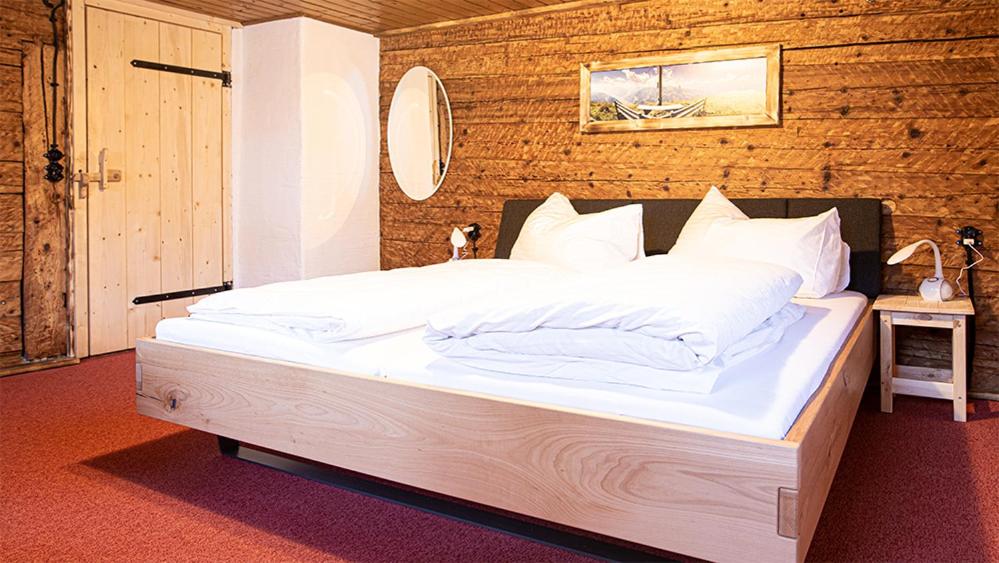 A bed or beds in a room at Landhaus Sommerbichl