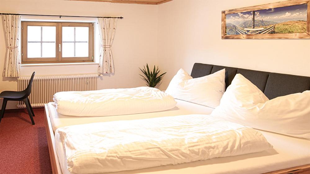 A bed or beds in a room at Landhaus Sommerbichl
