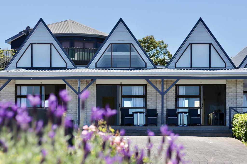 
a large building with a large window in front of it at Gables Lakefront Motel in Taupo
