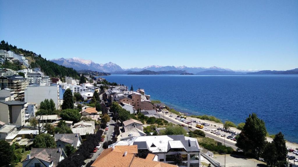 a town on a hill next to a body of water at Studio Center Bariloche in San Carlos de Bariloche