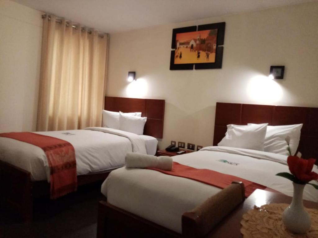 Postel nebo postele na pokoji v ubytování Golden Inca Hotel