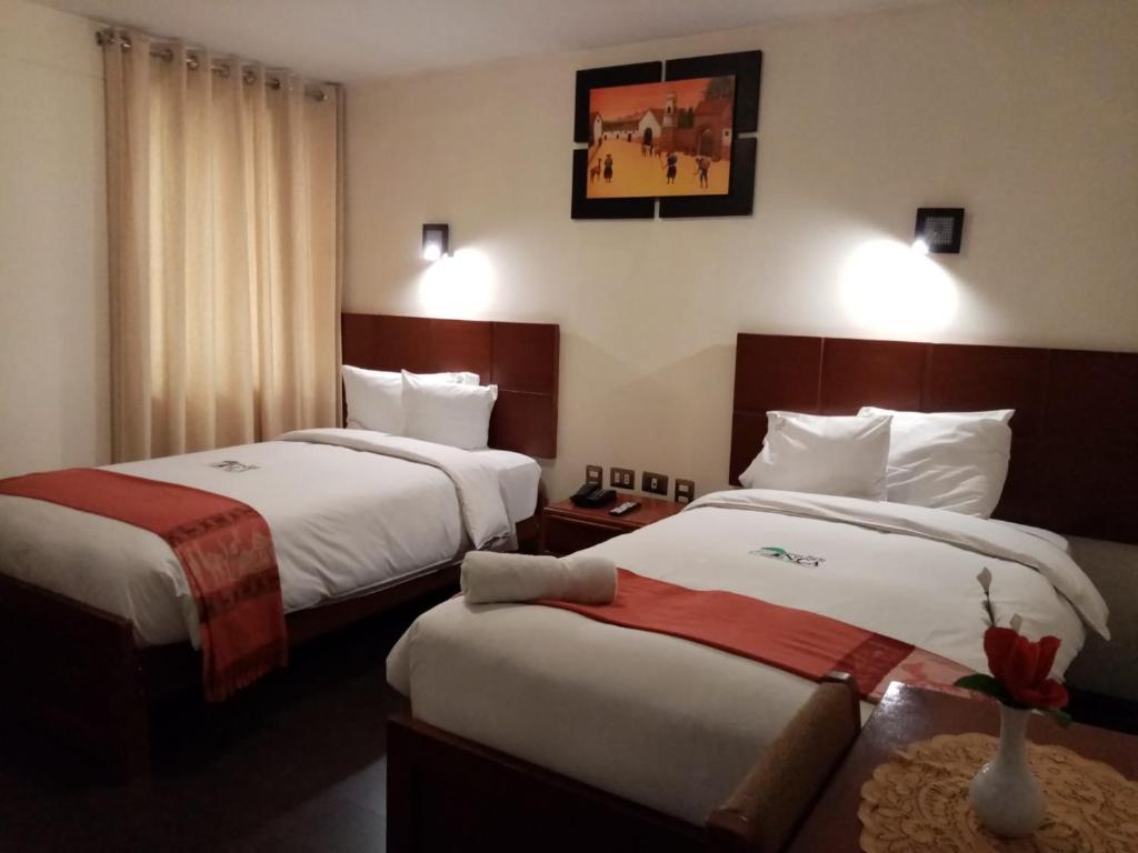 Postel nebo postele na pokoji v ubytování Golden Inca Hotel