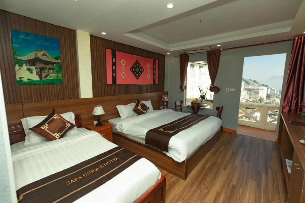 Postel nebo postele na pokoji v ubytování Sapa Unique Hotel