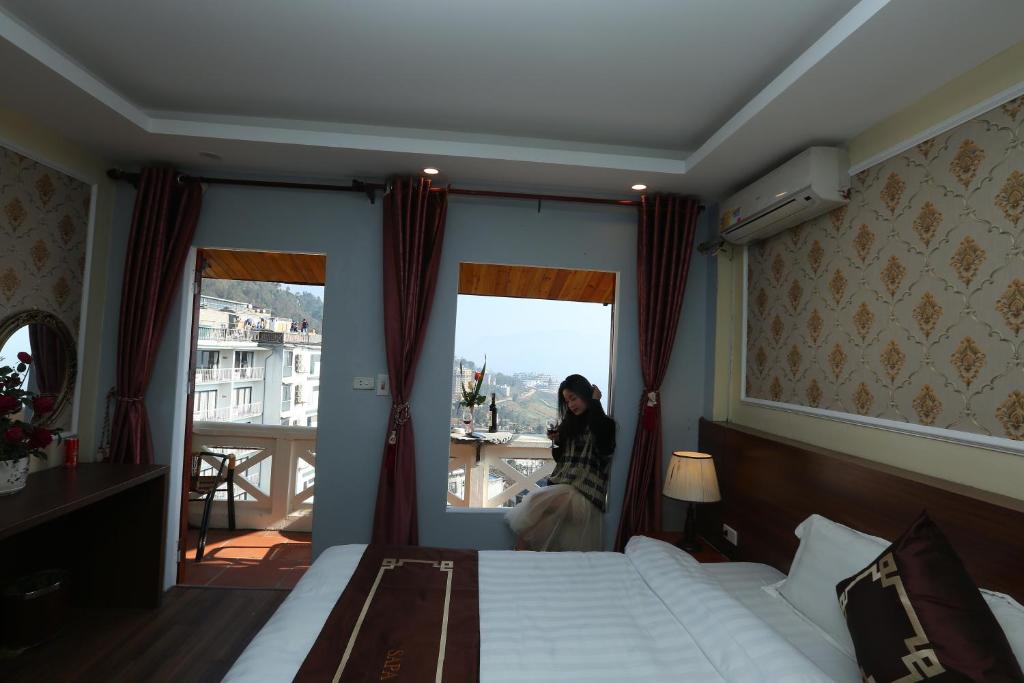 Postel nebo postele na pokoji v ubytování Sapa Unique Hotel