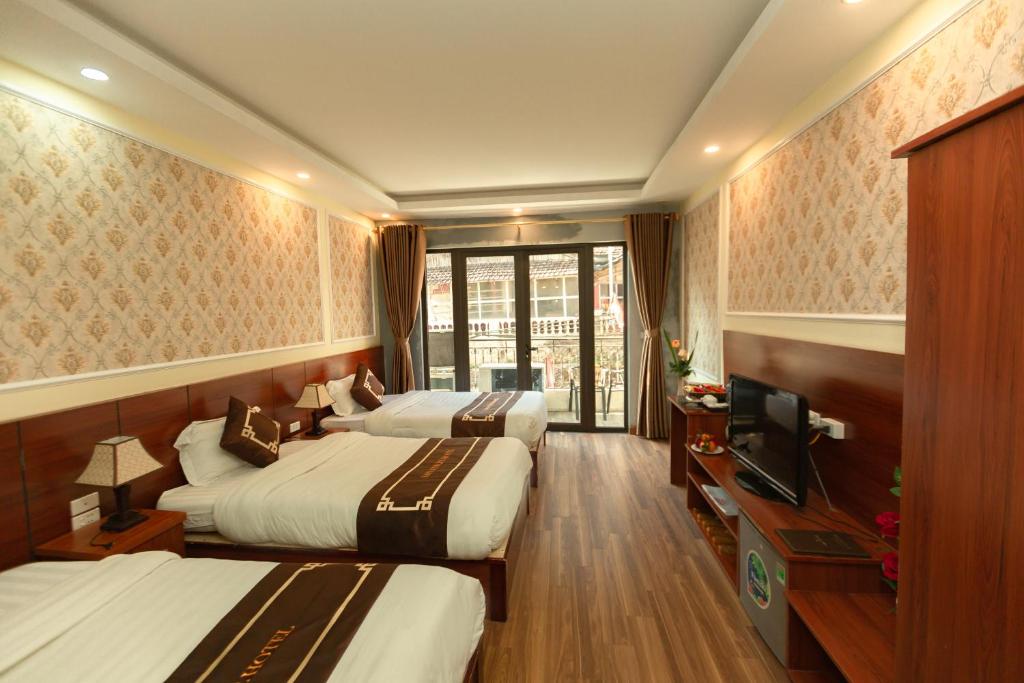 Postel nebo postele na pokoji v ubytování Sapa Unique Hotel