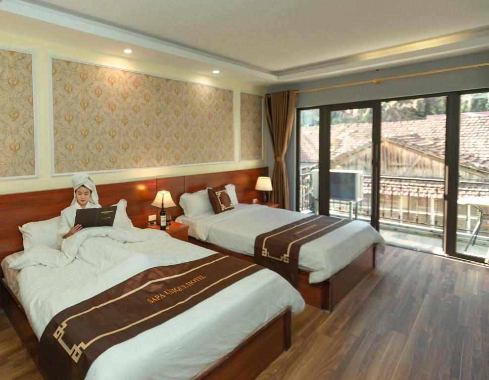 Postel nebo postele na pokoji v ubytování Sapa Unique Hotel