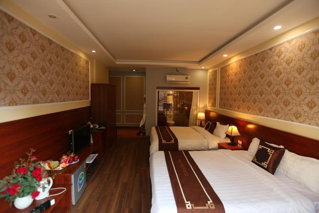Postel nebo postele na pokoji v ubytování Sapa Unique Hotel